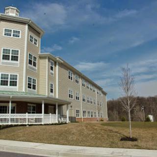 A modern residential building set against a clear blue sky.