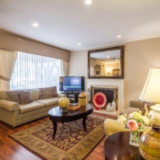 A cozy living room with a sofa, fireplace, and television for relaxation.