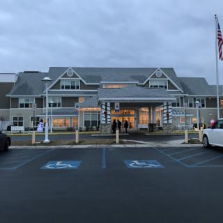 The exterior of a hospitality establishment with accessible parking and an inviting entrance.