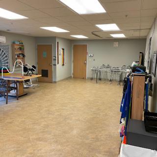 A spacious and well-lit interior room, equipped with various furniture and equipment.