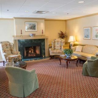 A cozy living room with a fireplace and comfortable seating.