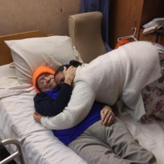 A heartfelt moment of support and affection in a hospital setting.