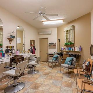 A cozy salon interior with multiple chairs and mirrors set up for hair styling.