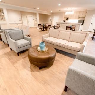 A modern living room with comfortable seating and an open kitchen layout.