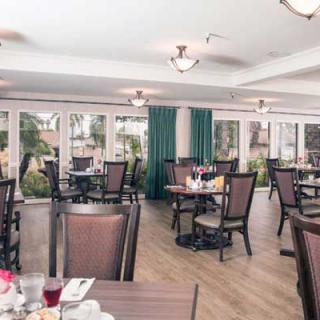 An interior view of a restaurant dining area with neatly arranged tables and chairs.