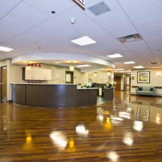 A spacious and modern lobby area with a reception desk.