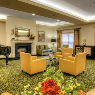Elegant living room with a cozy seating area and a grand piano.