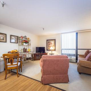A cozy living room with comfortable seating, a television, and warm decor.