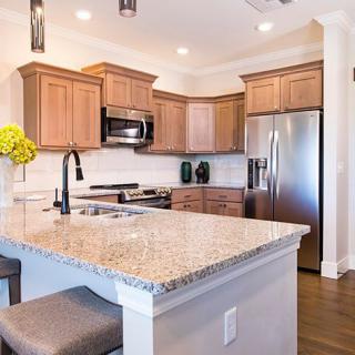 Modern kitchen with granite countertops and stainless steel appliances.