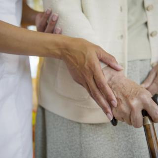 A caregiver assisting an elderly person.
