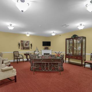 A traditionally styled living room with elegant furniture and warm lighting.