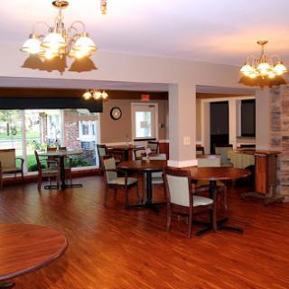 A cozy dining area featuring wooden furniture and warm lighting.