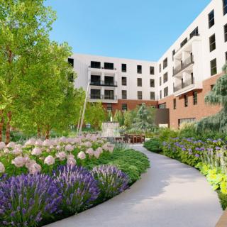 A beautiful garden with colorful flowers and a pathway, surrounded by a modern residential building.