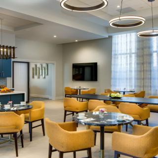 A modern dining area with comfortable seating and stylish lighting.