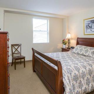 A cozy bedroom with classic wooden furniture and elegant decor.