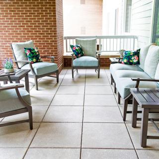 A cozy outdoor patio area with comfortable seating and cushions.