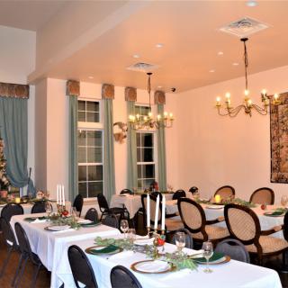 A beautifully decorated dining room set for a formal banquet.