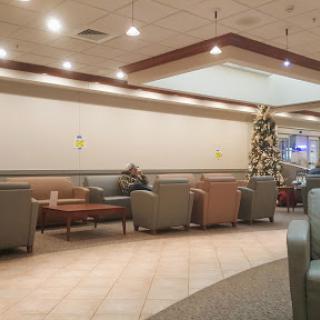 A cozy waiting area featuring comfortable seating and festive decor.