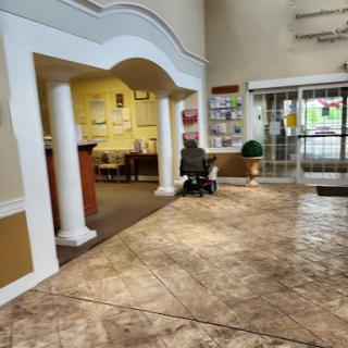 A spacious lobby area with comfortable seating and decorative columns.