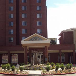 A hotel building with a prominent entrance and landscaped surroundings.