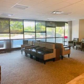 Spacious lobby area with seating and large windows.