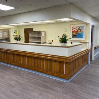 A welcoming reception area featuring wood paneling and bright, modern decor.