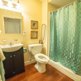A cozy bathroom with a sink, toilet, and shower curtain.