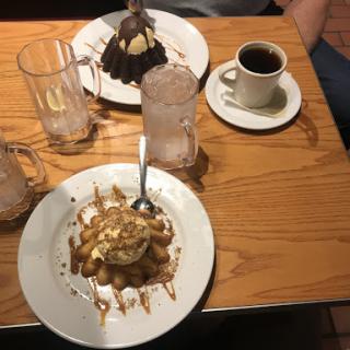 A delightful spread of desserts featuring ice cream and chocolate, paired with a warm cup of coffee.