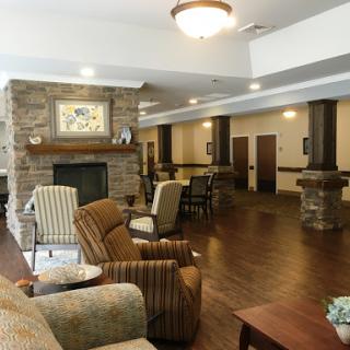 A cozy lobby area featuring comfortable seating and a stone fireplace, perfect for relaxation.
