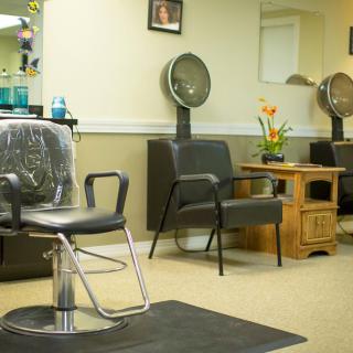 Interior of a hair salon with styling chairs and hair dryers.