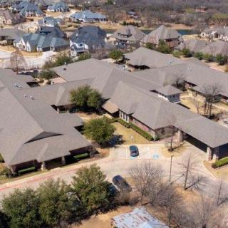 Aerial view of a suburban neighborhood with multiple houses and trees.