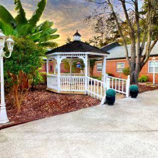 A charming gazebo nestled in a serene garden setting, perfect for relaxation and enjoying nature.