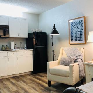 A cozy apartment interior with a kitchen and a comfortable seating area.