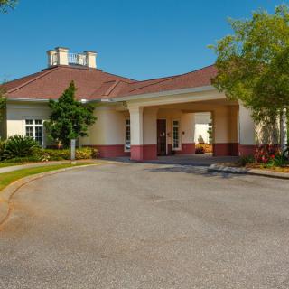 The entrance of a large medical facility with a circular driveway.