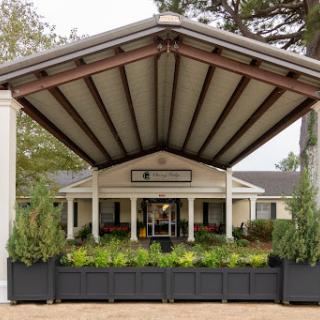 A welcoming entrance featuring a large canopy and well-maintained landscaping.