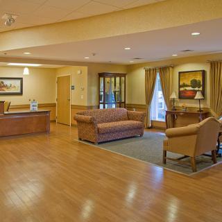 A cozy reception area with comfortable seating and warm lighting.