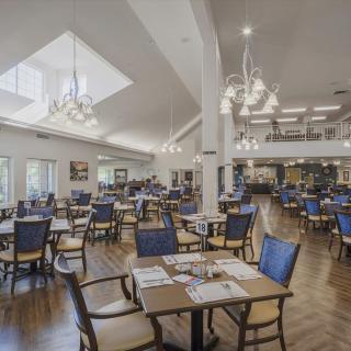 Spacious and elegant dining area with modern furnishings and chandeliers.