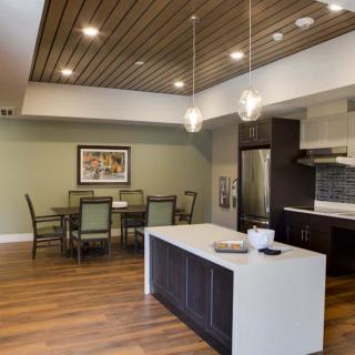 Modern kitchen and dining area with sleek design and wooden accents.