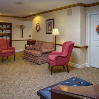 A cozy living room with comfortable seating and a bookshelf.