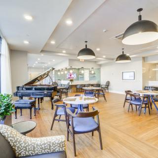 A modern cafe with comfortable seating and elegant lighting.