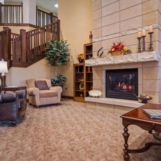A cozy living room with a fireplace and comfortable seating.