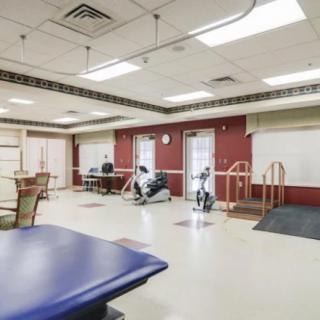 A rehabilitation center exercise room equipped with various fitness machines and therapy equipment.