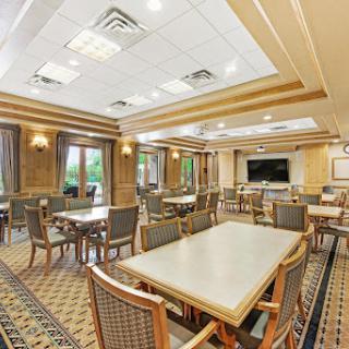 A spacious and elegantly designed dining area with tables and chairs, perfect for social gatherings.