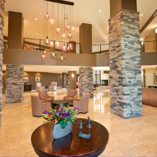 A welcoming lobby featuring modern design elements, stone pillars, and elegant lighting.