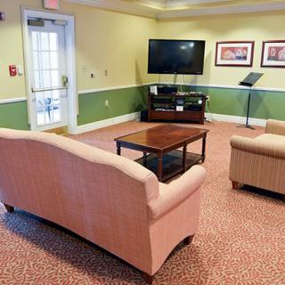 A cozy living room with a sofa, television, and coffee table.