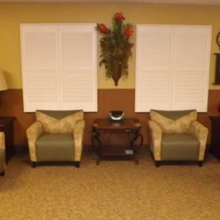 Cozy living room with armchairs and decorative elements.