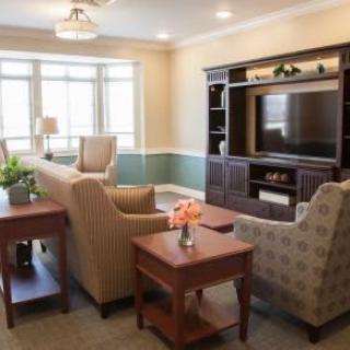 A cozy living room with comfortable seating and a large television.