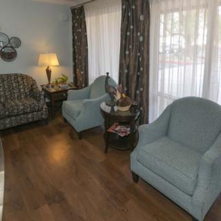 A cozy living room featuring comfortable seating and warm lighting.