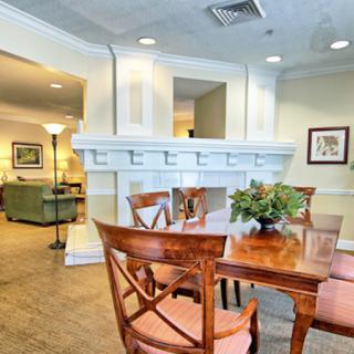 A cozy dining area with wooden furniture and elegant decor, adjacent to a living room space.