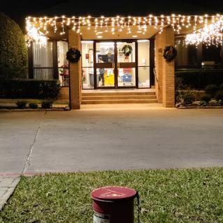 A warmly lit entrance adorned with festive lights, welcoming guests during the holiday season.